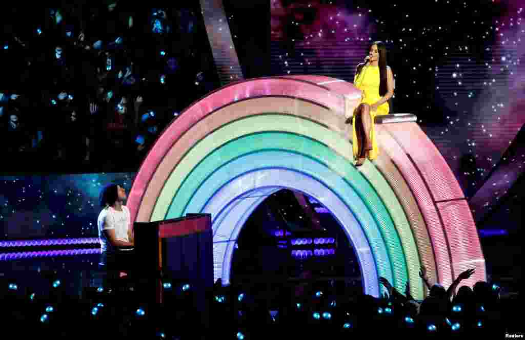 Singers Kacey Musgraves and Chris Martin perform during the iHeartRadio Music Awards in Los Angeles, California, U.S., March 14, 2019.