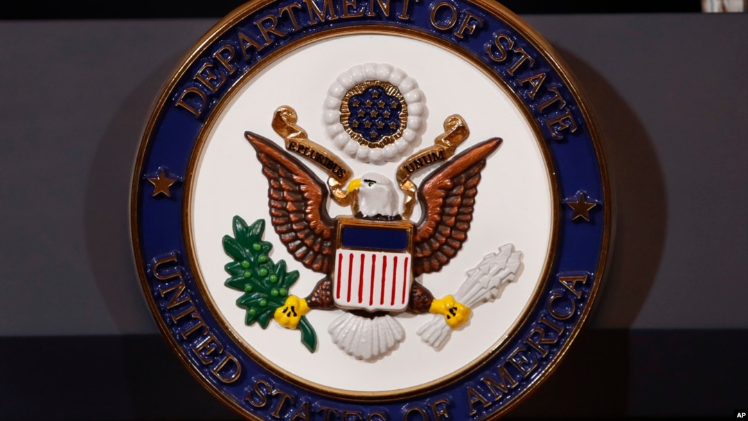 The seal of the State Department is seen on the podium as Secretary of State Mike Pompeo makes a statement about refugees to the media, Sept. 17, 2018, at the State Department in Washington.