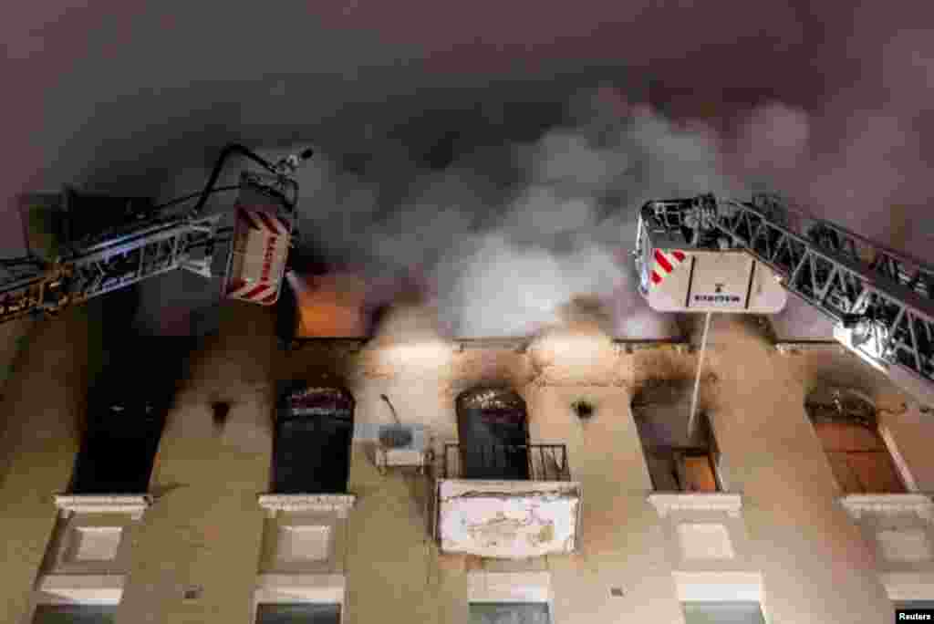 Firefighters work to extinguish a blaze that broke out on the upper floors of an apartment block in Moscow, Russia, in this handout photo released by Russian Emergencies Ministry.