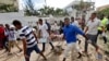 Somali men carry away the body of a civilian who was killed in a militant attack on a restaurant in Mogadishu, Somalia Thursday, June 15, 2017. 