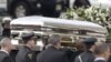 The coffin holding the remains of singer Whitney Houston is carried to a hearse in February 2012, after funeral services in New Jersey, which were seen by millions online. 