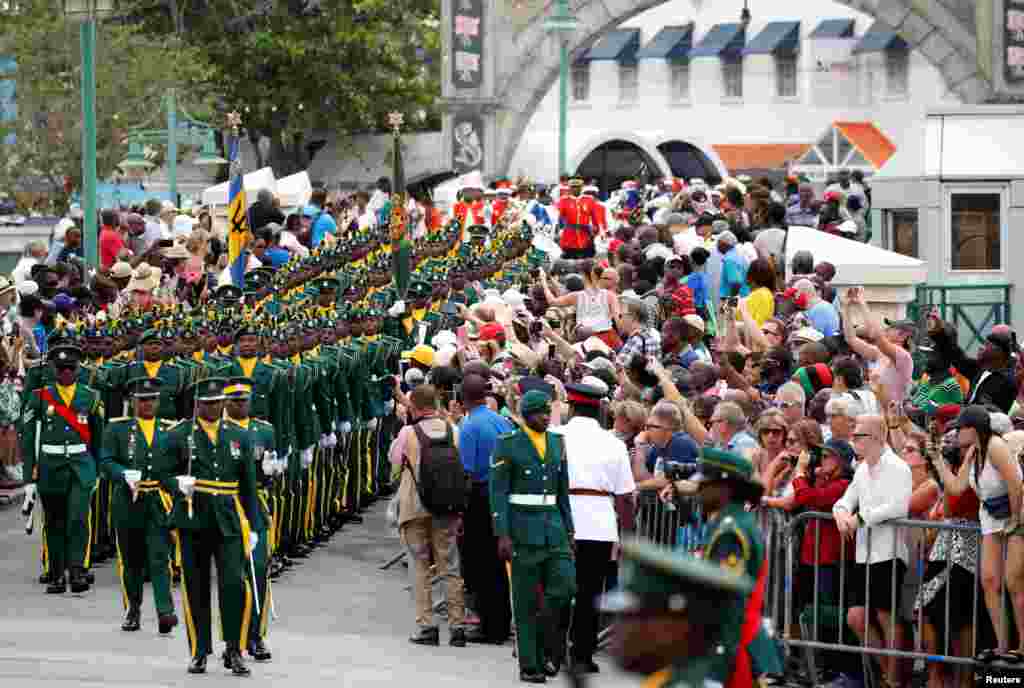 An honor guard marches before the arrival of Britain's Prince Charles and Camilla, Duchess, of Cornwall on a visit to Barbados.