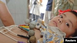 FILE - Liu Haocheng, five years old, receives Hepatitis A vaccine at the People's Hospital of Sixian county, China's Anhui province, June 28, 2005.