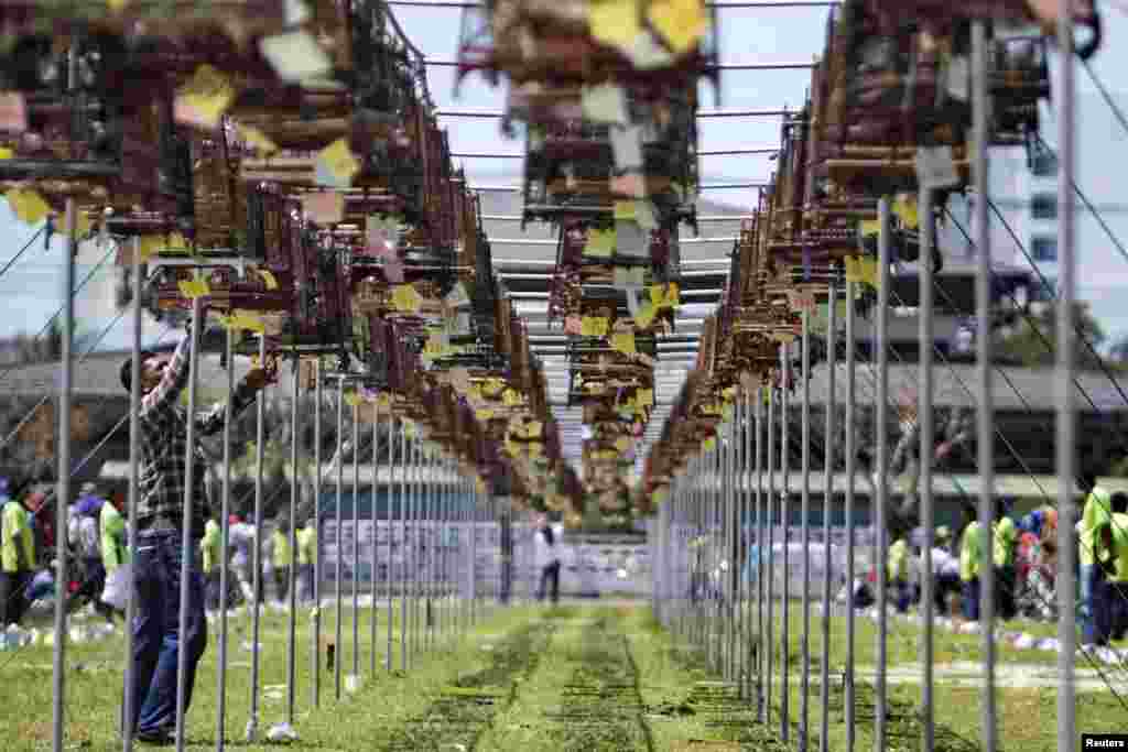 Thai Muslim villagers prepare birds and cages for a bird-singing contest in Yala province in southern Thailand, March 2, 2014.