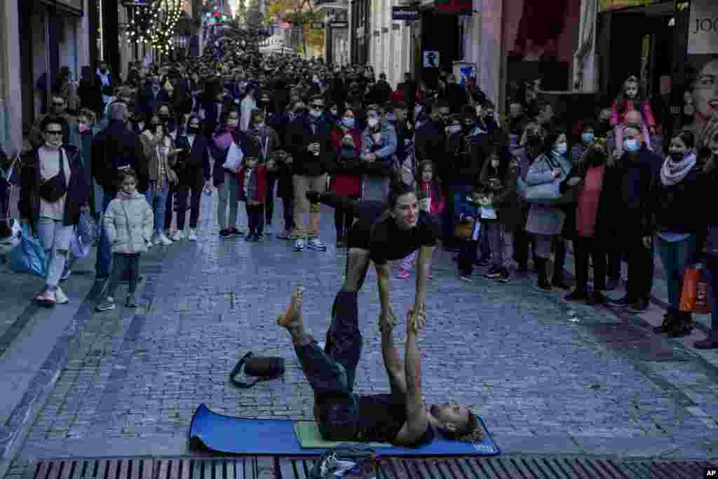 Street artists perform on Ermou Street, Athens' main shopping area.