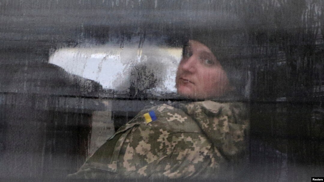 A detained Ukrainian serviceman and crew member of one of Ukrainian naval ships recently seized by Russia's FSB security service looks out of a minibus window outside a court building in Simferopol, Crimea, Nov. 28, 2018.