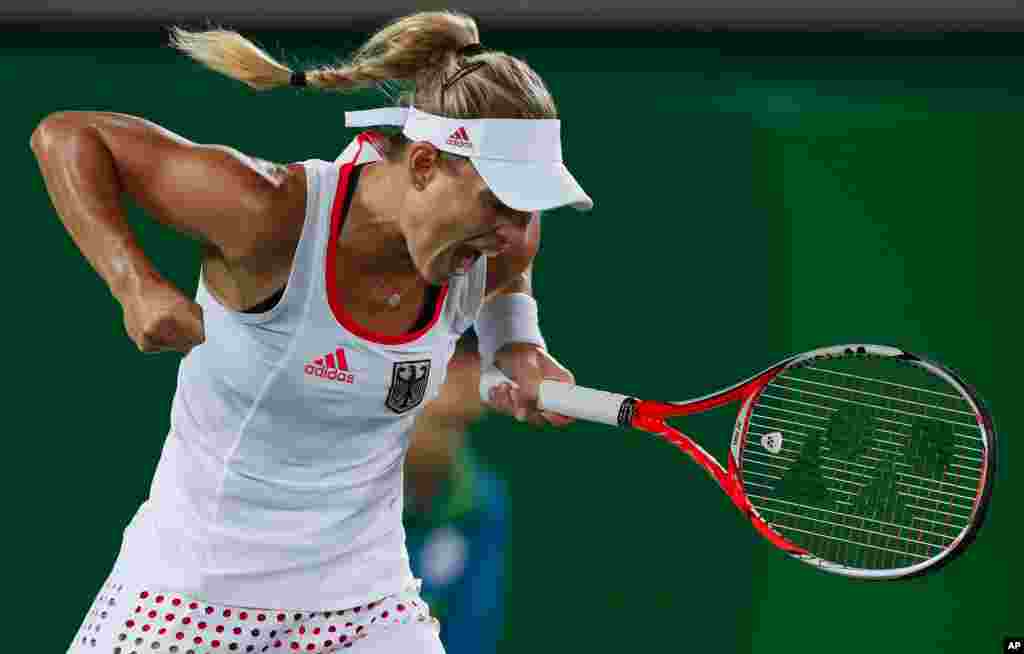 Germany's Angelique Kerber reacts after winning a set against Monica Puig of Puerto Rico in the gold medal match of the women's tennis competition at the 2016 Summer Olympics in Rio de Janeiro, Brazil, Aug. 13, 2016.