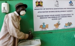 A man washes his hands with soap and water outside a retail market, amid concerns about the spread of coronavirus, in Nairobi, Kenya, April 2, 2020.