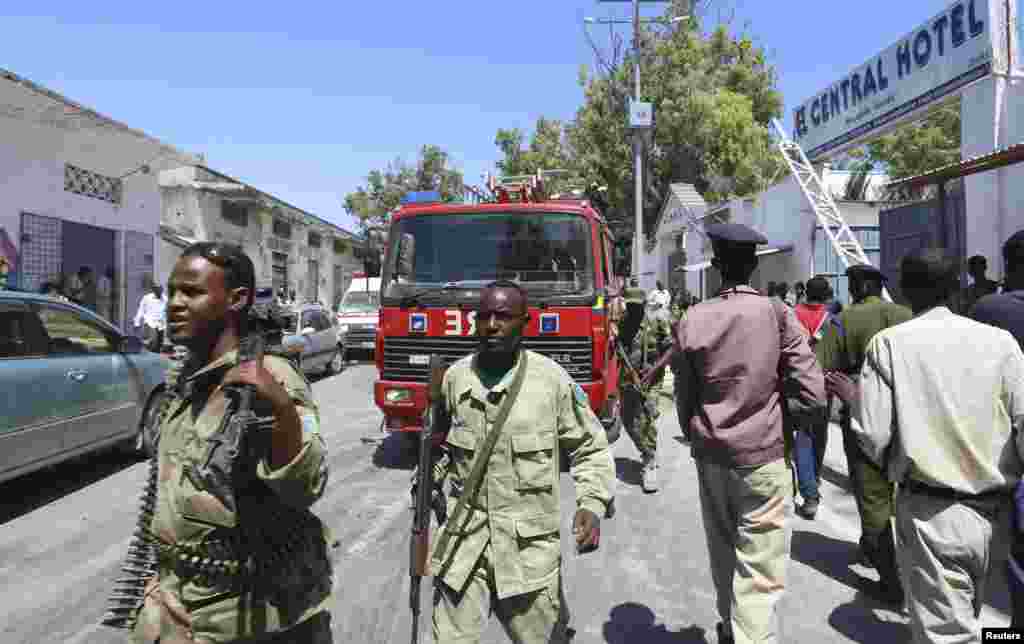 Somali security agents are seen outside the Central Hotel after a suicide attack in Somalia's capital Mogadishu.